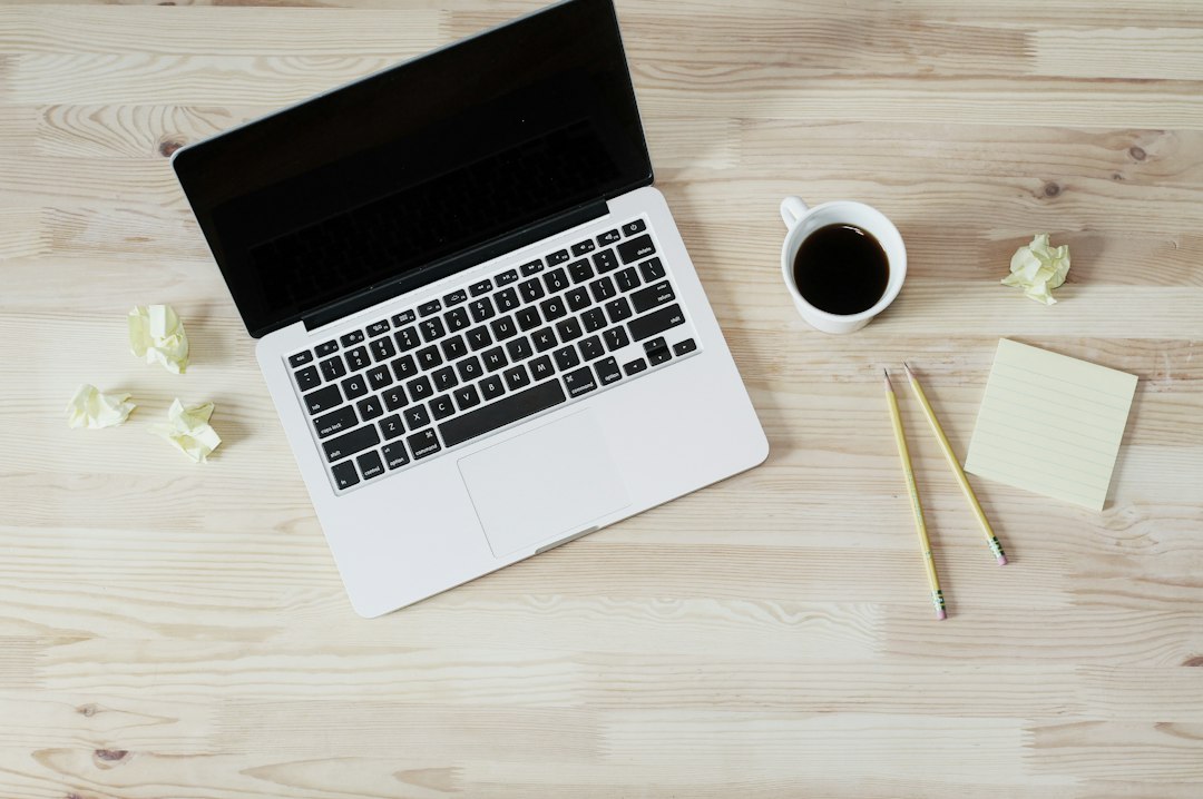 Payment processing elements including a card and smartphone laid out on an office desk.